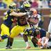 Michigan safety Jordan Kovacs and linebacker Kenny Demens bring down Illinois ball carrier running back Josh Ferguson the second quarter at Michigan Stadium on Saturday.  Melanie Maxwell I AnnArbor.com